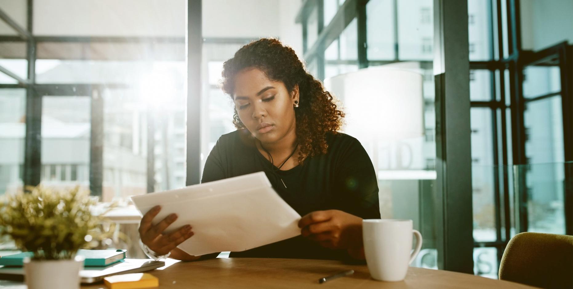 Person engaged in focused self-reflection exercise with structured materials